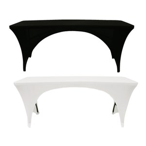 May include: Two tablecloths, one black and one white, are draped over a table. The tablecloths are designed to fit over the table and drape down the sides, covering the legs.