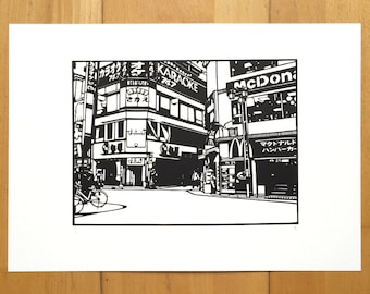 May include: Black and white illustration of a street scene in Japan. The image features buildings with Japanese text, a McDonald's restaurant, and a person riding a bicycle.