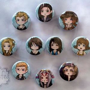 May include: Ten round, blue and white buttons featuring cartoon images of characters from a video game. The characters are depicted in a chibi style, with large heads and small bodies. The buttons are approximately 2.5 cm in diameter.