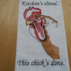 May include: White kitchen towel with an embroidered rooster and the text "Kitchen's closed. This chick's done."