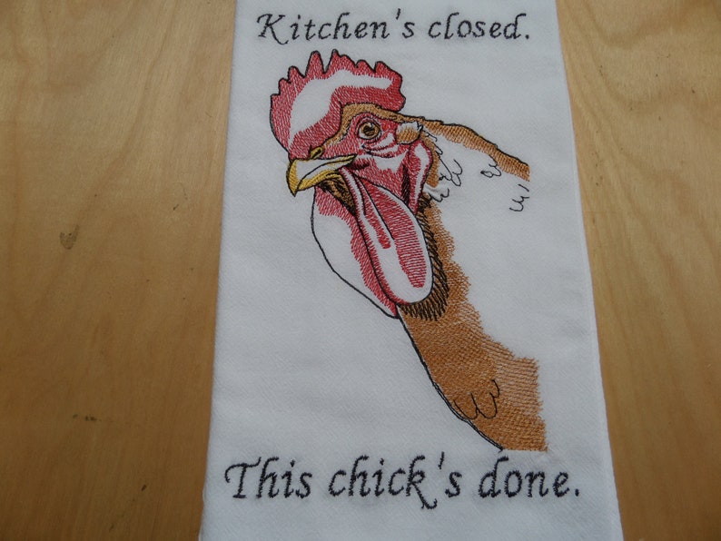 May include: White kitchen towel with an embroidered rooster and the text "Kitchen's closed. This chick's done."