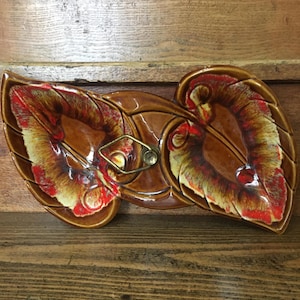 May include: A set of three ceramic mugs with a speckled, matte finish. The mugs are in shades of cream, light gray, and dark gray. Each mug has a simple, minimalist design, perfect for coffee or tea.