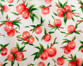 May include: A repeating pattern of ripe peaches on a cream-colored background. The peaches are a vibrant mix of red and orange, with green leaves and brown branches. The design is a watercolor style, creating a fresh, summery feel.