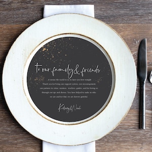 May include: A black and white wedding reception place card with gold glitter accents. The card reads "To our family & friends... it means the world to us to have you here tonight. Thank you for being our support system, our encouragement, our partners in crime, mentors, teachers, guides, and for loving us through our ups and downs. You have helped to make us who we are and for that, we are forever grateful. Kehray & Noak"