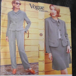May include: A Vogue Patterns sewing pattern envelope for Anne Klein II, number 1937, size 14-16-18. The cover displays two views of a grey suit: one with trousers and one with a skirt, both featuring a button-front jacket with a rounded collar.
