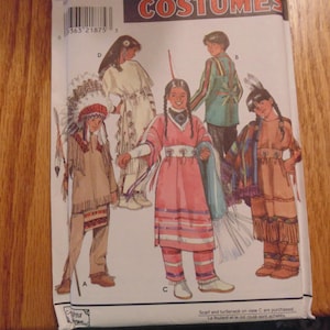 May include: A Simplicity Costumes sewing pattern envelope, number 8282, featuring illustrations of four different outfits labelled A, B, C, and D. The cover displays various styles of fringed garments, headpieces, and patterned clothing for children.