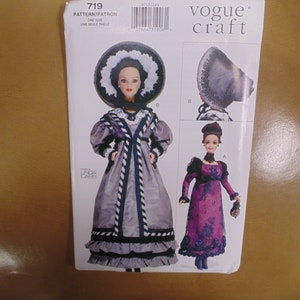 May include: Vogue Craft pattern 719 for a doll dress and hat. The pattern includes two different styles, one with a long, gray dress and a large hat, and the other with a shorter, purple dress. The pattern is for one size.