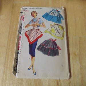 May include: Simplicity Printed Pattern #1391 for one-yard aprons. The pattern includes three different apron styles: a gingham apron with a red trim, a blue apron with a white trim, and a yellow floral apron with a white trim. The pattern is 35 cents.