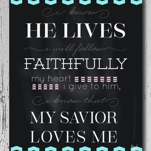 May include: Black chalkboard with white text that reads "I know HE LIVES, I will follow FAITHFULLY, my heart I give to him, I know that MY SAVIOR LOVES ME". The text is surrounded by a turquoise and white chevron border.