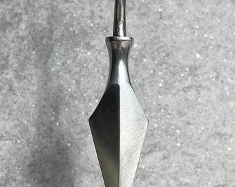 May include: A silver pendant necklace with a sharp, pointed, diamond-shaped design. The pendant is attached to a silver chain.