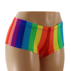 May include: Rainbow striped women's shorts with a high-waisted fit. The shorts are made of a stretchy, comfortable fabric and feature a vibrant rainbow pattern.