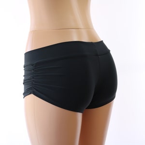 May include: Black dance shorts with a gathered detail on the back.
