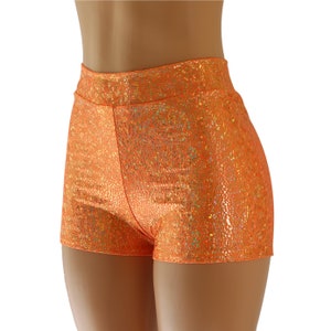 May include: Orange high-waisted shorts with a shimmery, iridescent finish. The shorts are made of a stretchy, comfortable fabric and have a flattering fit.