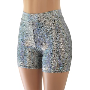 May include: High-waisted silver shorts with a mosaic-like pattern. The shorts are made of a shiny, iridescent fabric that reflects light. The shorts are form-fitting and have a high waistline. The shorts are designed for dance or activewear.