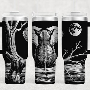 May include: A black and silver stainless steel tumbler with a handle. The tumbler features a graphic of an elephant standing in front of a tree with a full moon in the background.