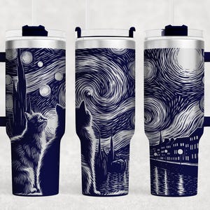 May include: A stainless steel travel mug with a navy blue exterior and a white design of a starry night sky with two cats looking up at the stars. The mug has a handle and a lid.