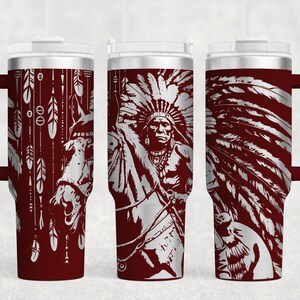May include: A red stainless steel travel mug with a handle. The mug features a white design of a Native American chief wearing a headdress and riding a horse. The design is repeated on all sides of the mug.