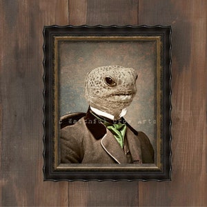 May include: Framed vintage portrait of a reptile wearing a suit and tie. The reptile has a textured head and is wearing a brown suit with a green tie. The frame is black and ornate.