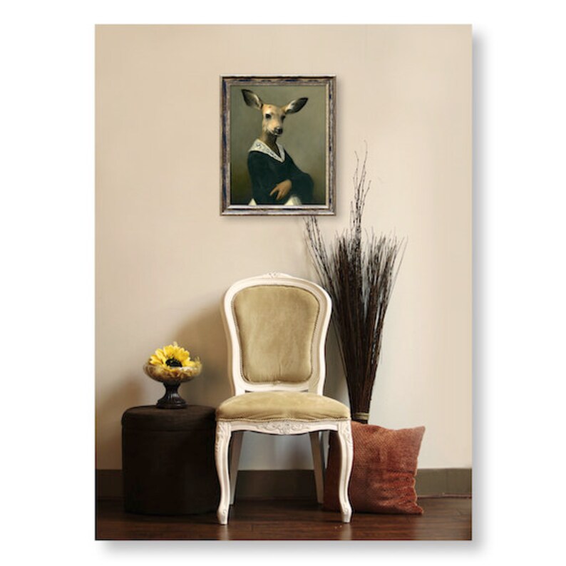 May include: A framed painting of a deer wearing a black dress and a white lace collar. The painting is hanging on a wall in a room with a chair and a plant.