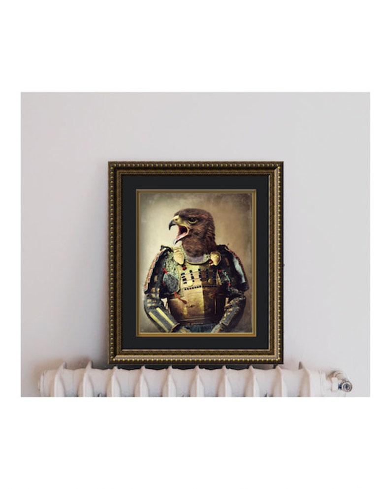 May include: A framed print of a brown and black hawk wearing a colorful samurai armor with a gold helmet. The hawk is looking to the left and has its mouth open. The background is a faded brown color.