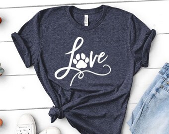 May include: A navy blue t-shirt with a white graphic of the word "Love" with a paw print in the "o".