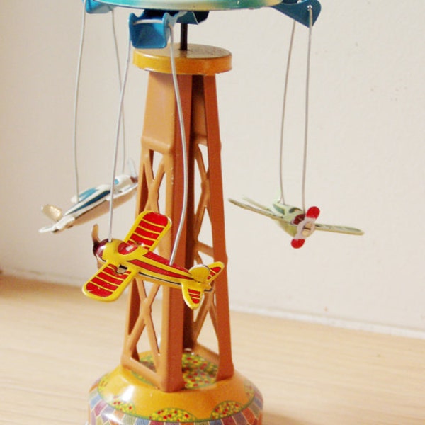 Vintage carnival ride with aeroplanes, retro collectible toy, colourful carousel toy  reproduction with lever, early nineties