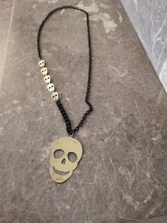 Skull tin necklace, large skull necklace on black chain with smaller skulls chain on one side, vintage Halloween necklace