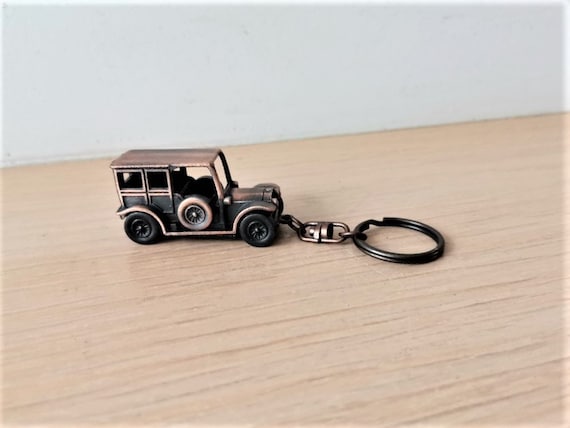 Vintage old car key ring, brass-copper oxidised antique car miniature on key chain, retro automobile miniature key ring