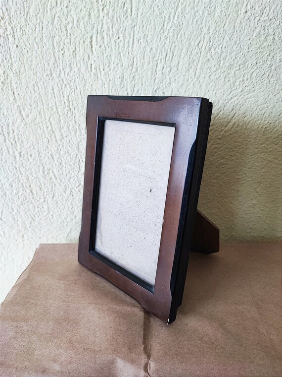 Wooden photo frame, vintage photo display of dark brown wood, natural wooden frame with wooden back