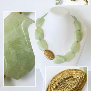 May include: A necklace featuring light green, irregularly shaped, polished stone beads interspersed with small gold-toned metal spheres and a single, larger, oval-shaped gold-toned metal bead with a textured, ridged surface finish.