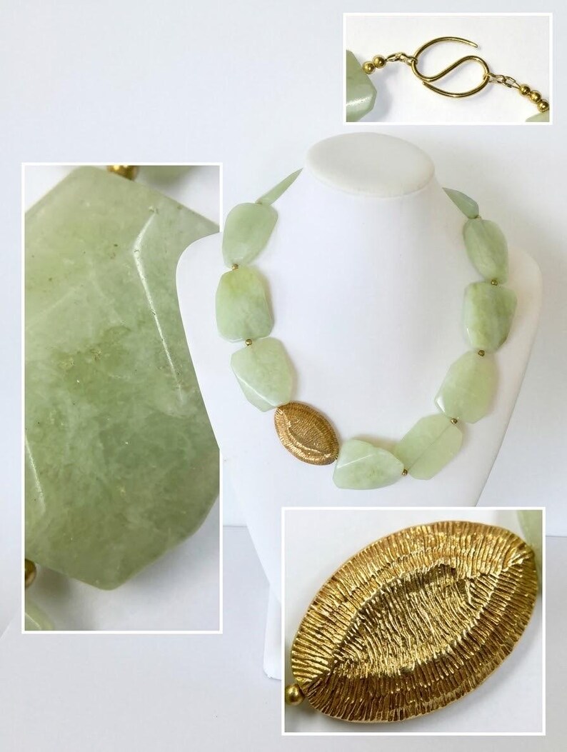 May include: A necklace featuring light green, irregularly shaped, polished stone beads interspersed with small gold-toned metal spheres and a single, larger, oval-shaped gold-toned metal bead with a textured, ridged surface finish.
