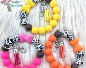Beaded cow print with bow keychain bracelet