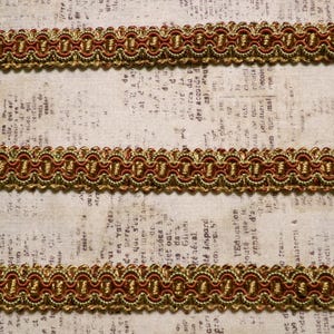 May include: Red and gold trim with a scalloped edge. The trim is made of woven fabric and has a subtle sheen.