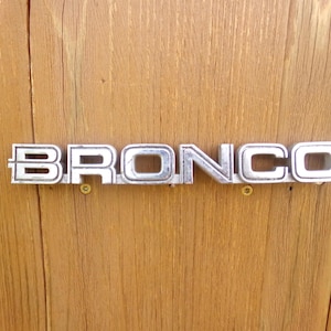 Bronco Emblem SUV Accessory Silver Plastic Vintage Used Brand OEM Factory Authentic Real Original Model Number Ford Name