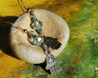 Hamsa hand charm earrings, with sky blue faceted glass. Silver plated Hand of Fatima protective amulet gift.