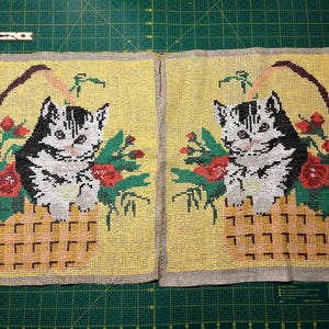 May include: Two embroidered pillow covers featuring a black and white cat sitting in a basket of flowers. The flowers are red, yellow, and green. The background is a yellow fabric.
