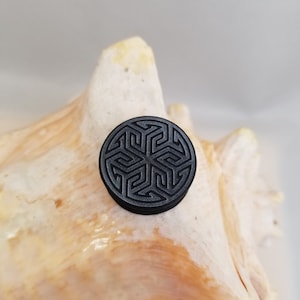 Pair black silicone plugs with printed star pattern on the front double flare