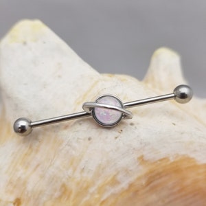 14G industrial barbell with imitation white opal planet charm