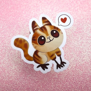 May include: A cute cartoon sticker of a brown and white striped animal with big eyes and a heart above its head. The animal is smiling and has a long tail.