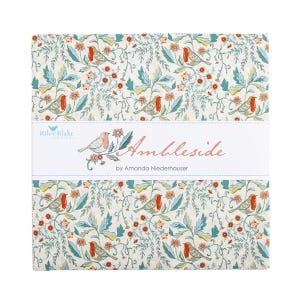 May include: A stack of fabric squares with a floral and bird pattern. The fabric features a cream background with teal leaves, orange flowers, and birds. The text "Ambleside by Amanda Niederhauser" is printed on a white band.