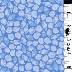 May include: A blue fabric featuring a repeating pattern of light blue seashells in various shapes and sizes. A white measuring tape is positioned along the right edge, showing a length of 5 inches with the brand name Dritz clearly printed.