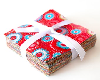 May include: A stack of red, white, and blue fabric squares with a white ribbon tied around them. The fabric has a pattern of circles and swirls.