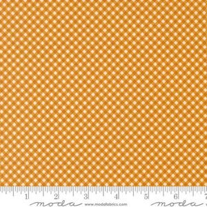 May include: A fabric swatch featuring a diagonal gingham pattern in mustard yellow and white. The fabric is positioned above a white ruler that measures up to 7 inches, with the text moda and www.modafabrics.com printed along the bottom edge.