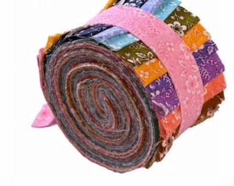 May include: A roll of colorful fabric scraps, perfect for quilting or crafting. The fabric is arranged in a spiral pattern and tied with a pink ribbon.