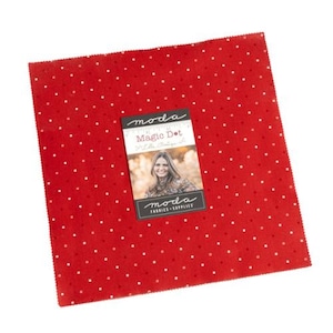 May include: Red fabric with white polka dots. The fabric has a label that says "moda Magic Dot Little Bunny".