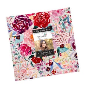 May include: A square stack of fabric squares featuring a watercolor floral pattern in shades of red, pink, purple, and teal. A central paper label displays the text moda, Fleur the Love, CREATE JOY PROJECT, and moda FABRICS + SUPPLIES.