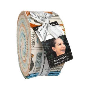 May include: A roll of fabric strips in various colors, including orange, blue, and cream. The fabric is tied with a white ribbon and a tag that reads "moda FABRICS + SUPPLIES". The fabric is labeled "GIRAFFE".