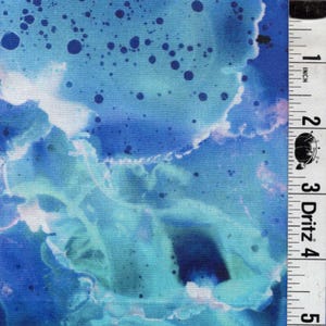 May include: Abstract fabric with a watercolor effect in shades of blue and teal. The design features splatters and flowing patterns, creating a dynamic and artistic look. The fabric is measured with a ruler in inches.