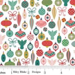 May include: A white fabric featuring a repeating pattern of colorful Christmas ornaments, including spheres, teardrops, and angels in red, green, pink, and gold, with a ruler at the bottom showing a scale of 5 inches by Riley Blake Designs.