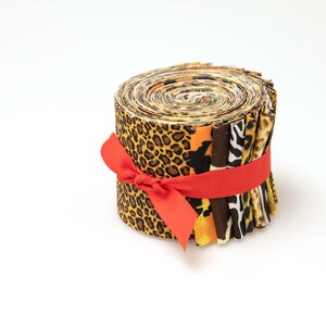 May include: A roll of fabric featuring a variety of animal print designs, including leopard, zebra, and cheetah. The fabric is tied with a red ribbon.